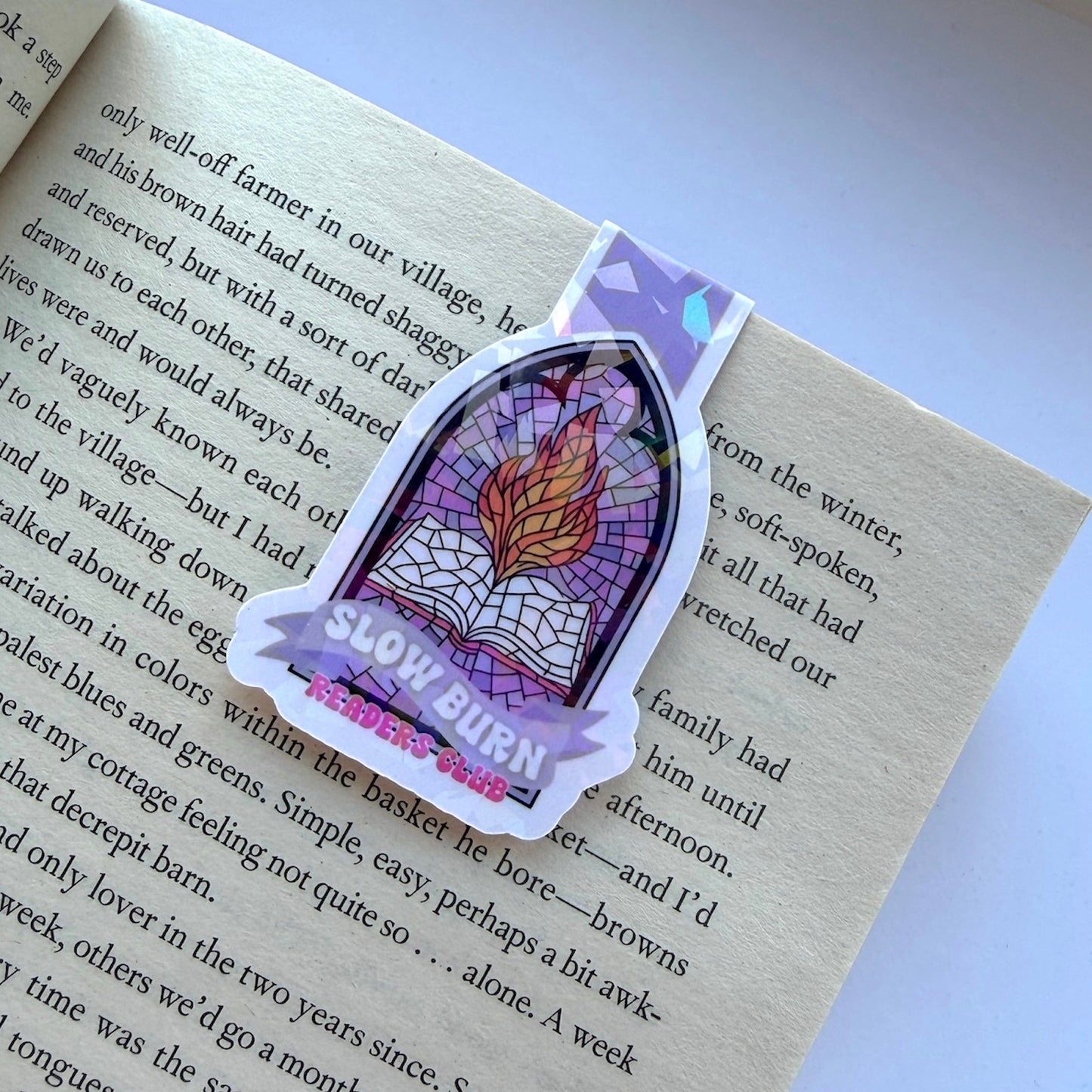 Sticker with a stained glass design and 'Slow Burn' text on a book page.