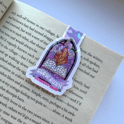 Sticker with a stained glass design and 'Slow Burn' text on a book page.